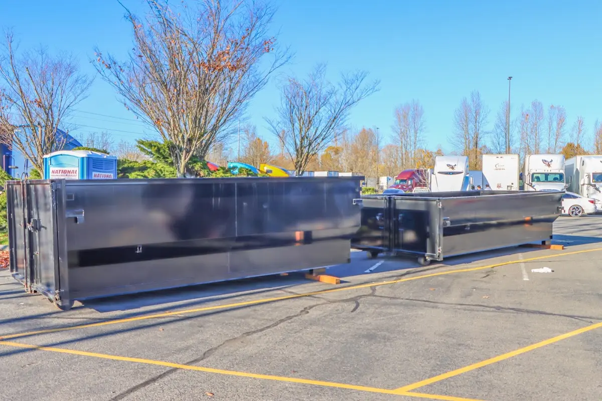 Professional dumpster rental service with roll-off container on residential driveway in Enfield